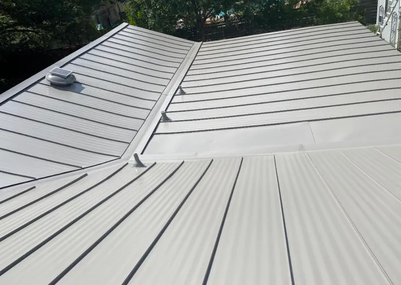 Solar attic fan installed on a metal roof for Roof Ventilation in East Moline